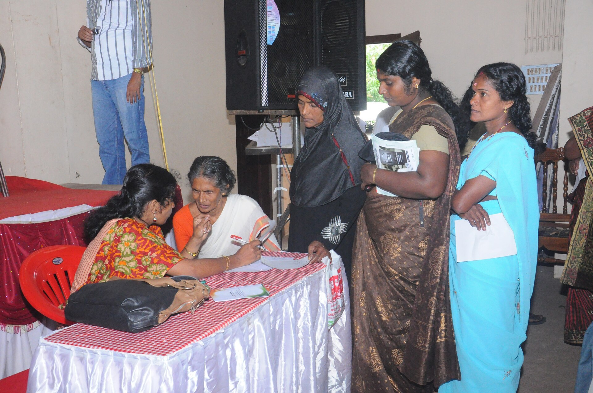 Community members at a health awareness camp registration desk